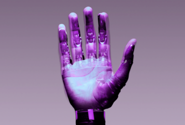 Stylized image of a held up hand with a robot hand super imposed on it.