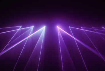 Refracted white light on a purple background.