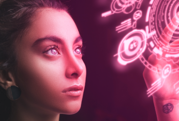 A young woman is shown looking at symbols shown as light. She points toward the centre of the image.